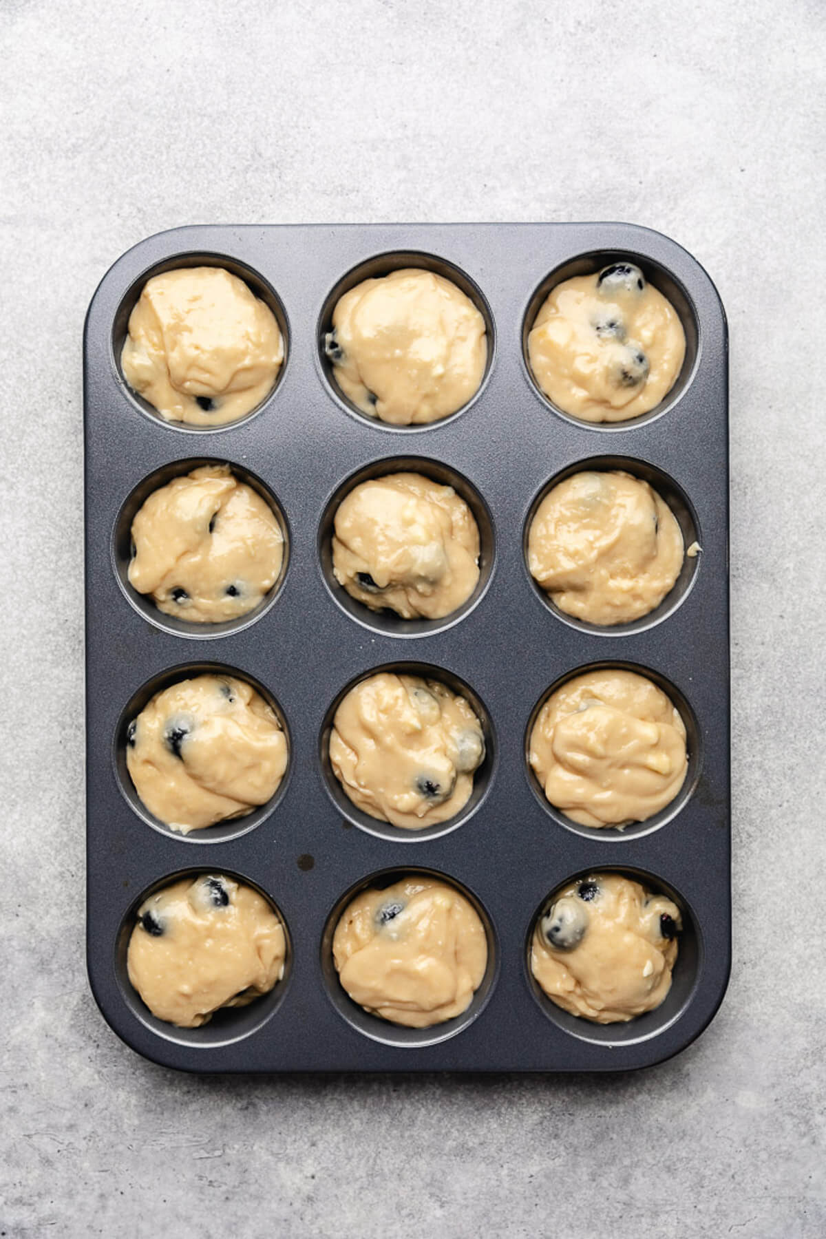 Unbaked muffin batter in a pan.