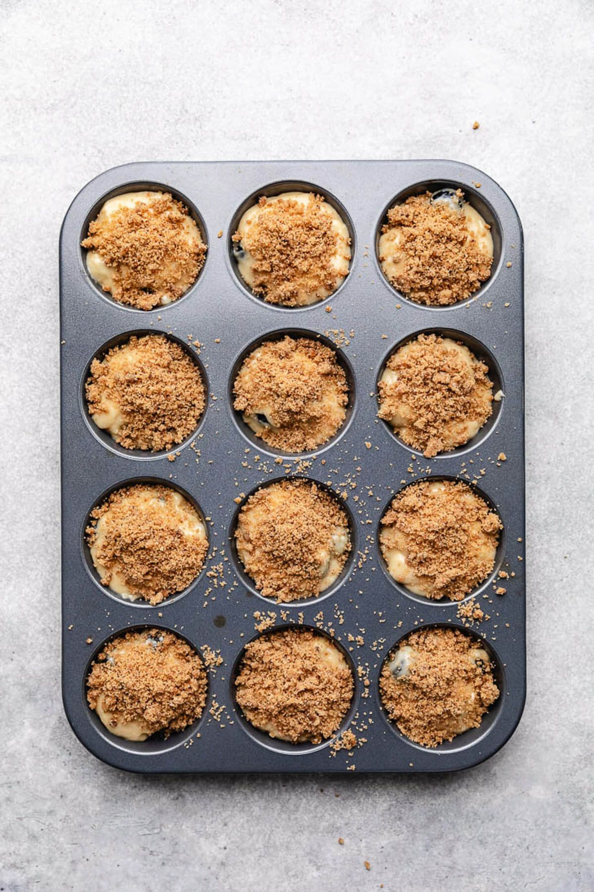 Crumb topping added to unbaked muffin batter.