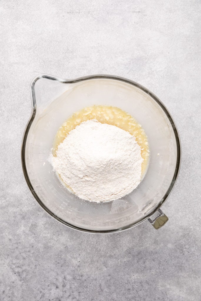 Flour mixture poured over butter mixed with oil and milk.