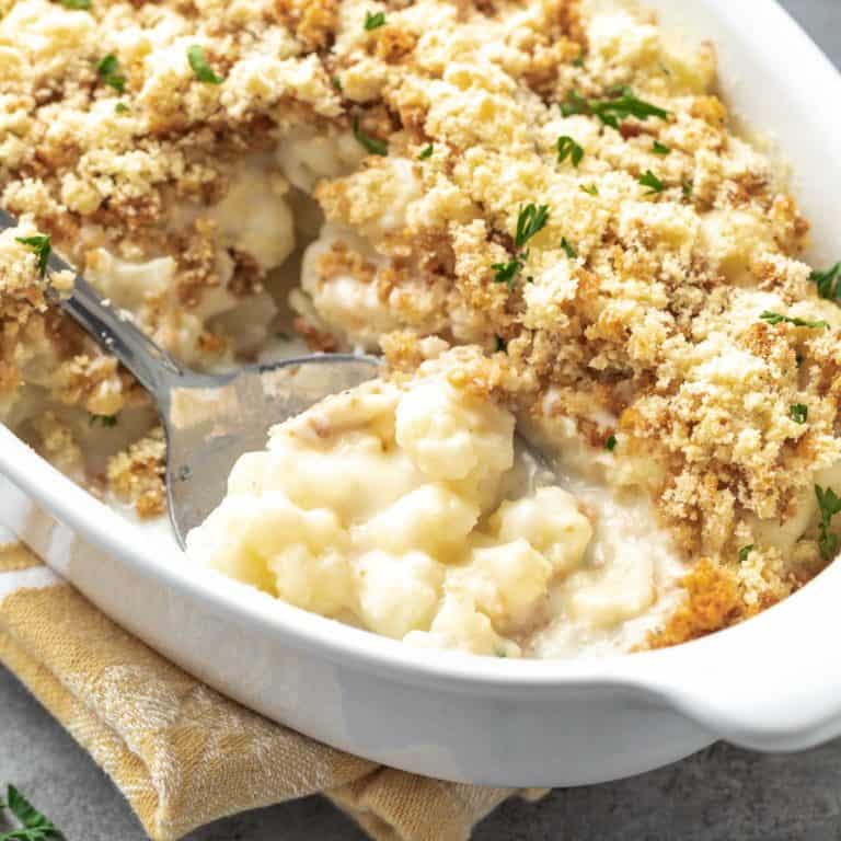 Close up view of cauliflower casserole with breadcrumbs in a dish.