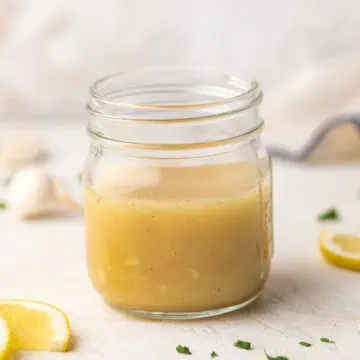 Close up view of a small jar of salad dressing.