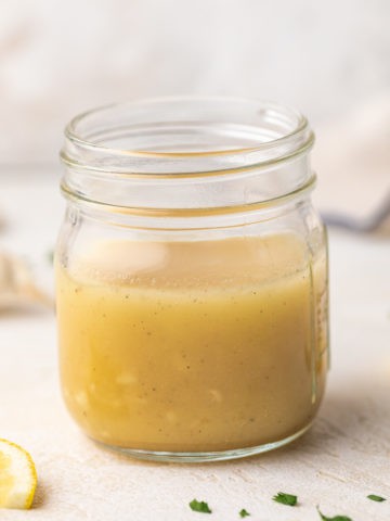 Close up view of a small jar of salad dressing.