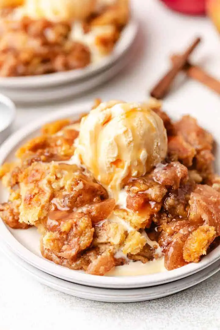 Close up view of caramel apple dump cake on plates.