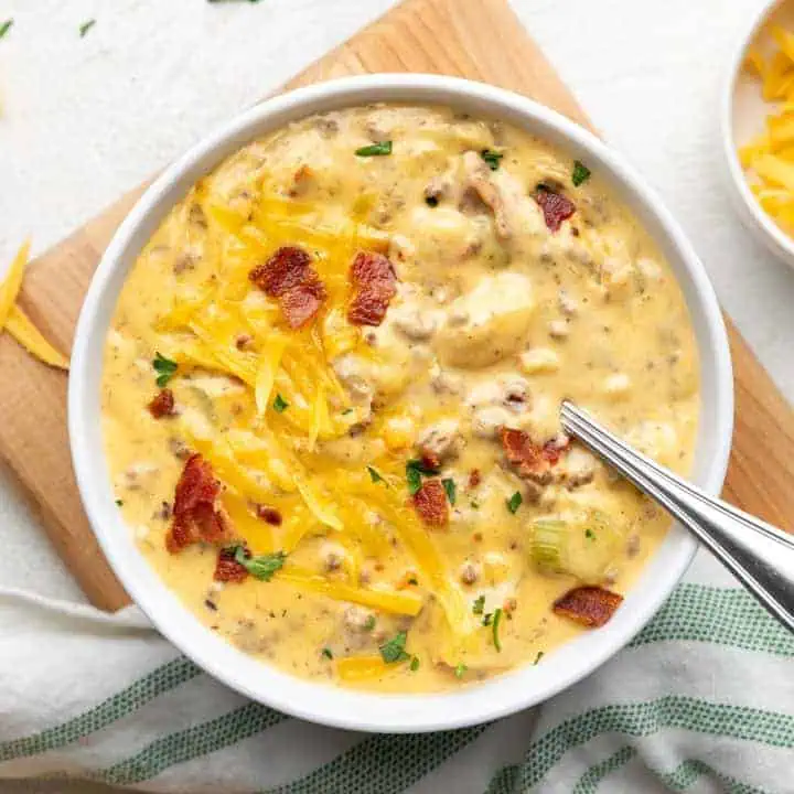 Top down view of a bowl of soup topped with melted cheese.