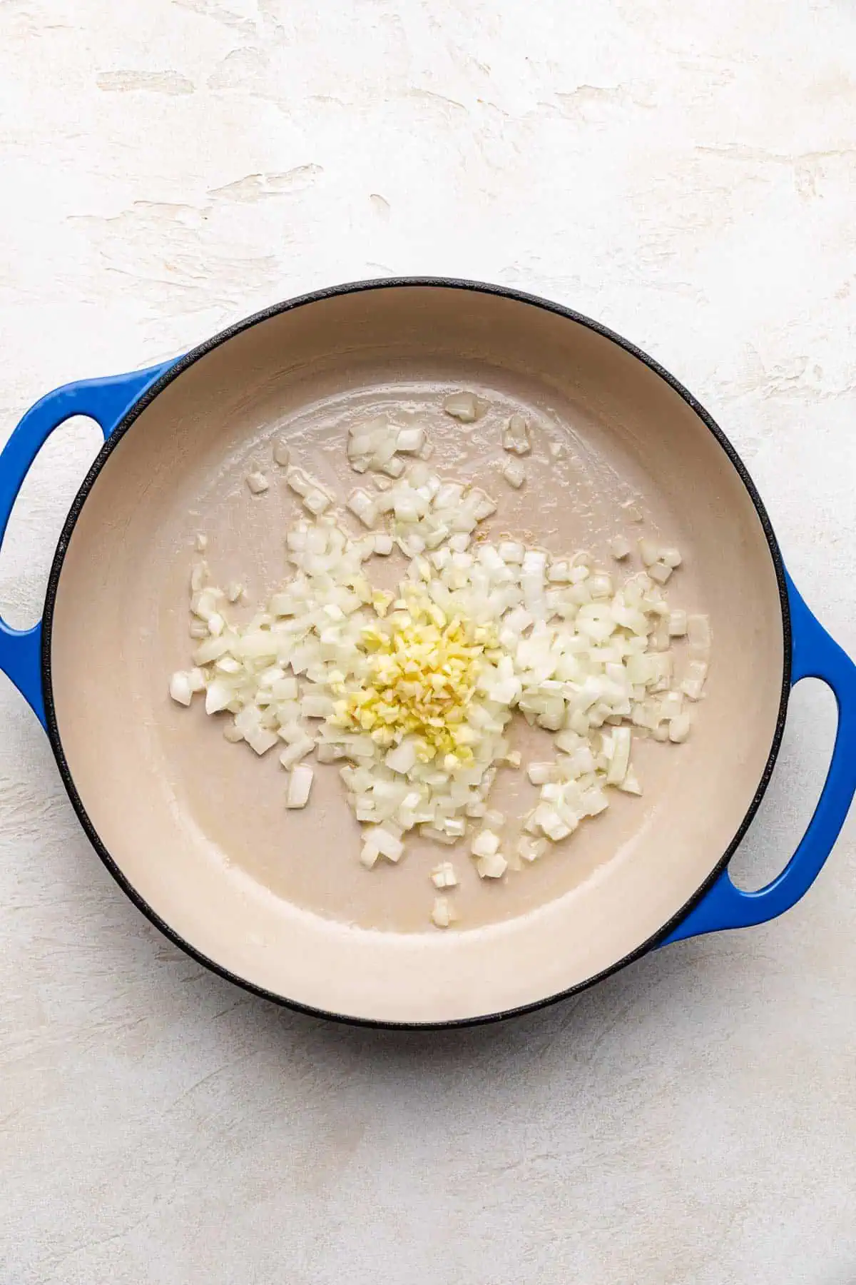 Garlic, onions, and butter in a pan.