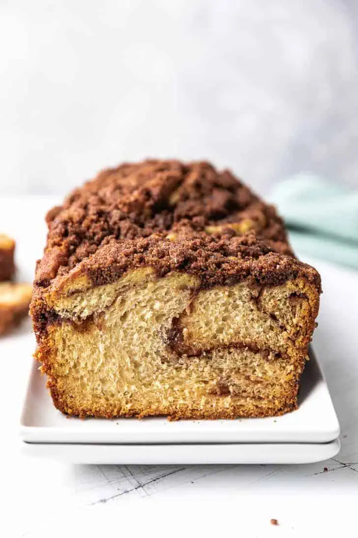 Crunchy cinnamon topping on top of a loaf of bread.