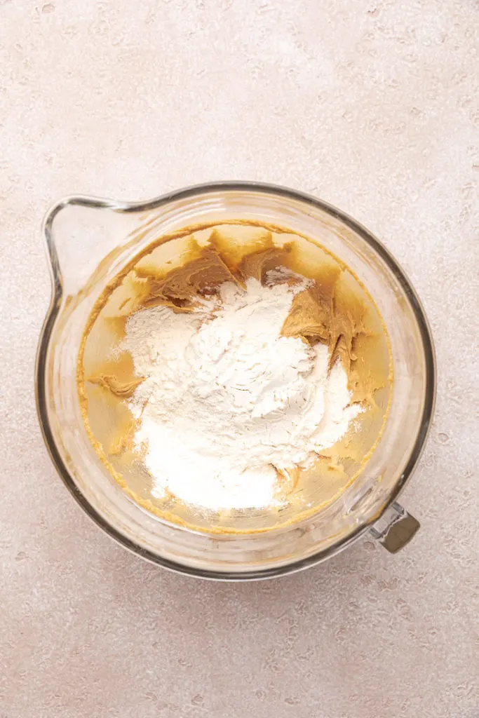 Flour added to peanut butter and sugar mixture.