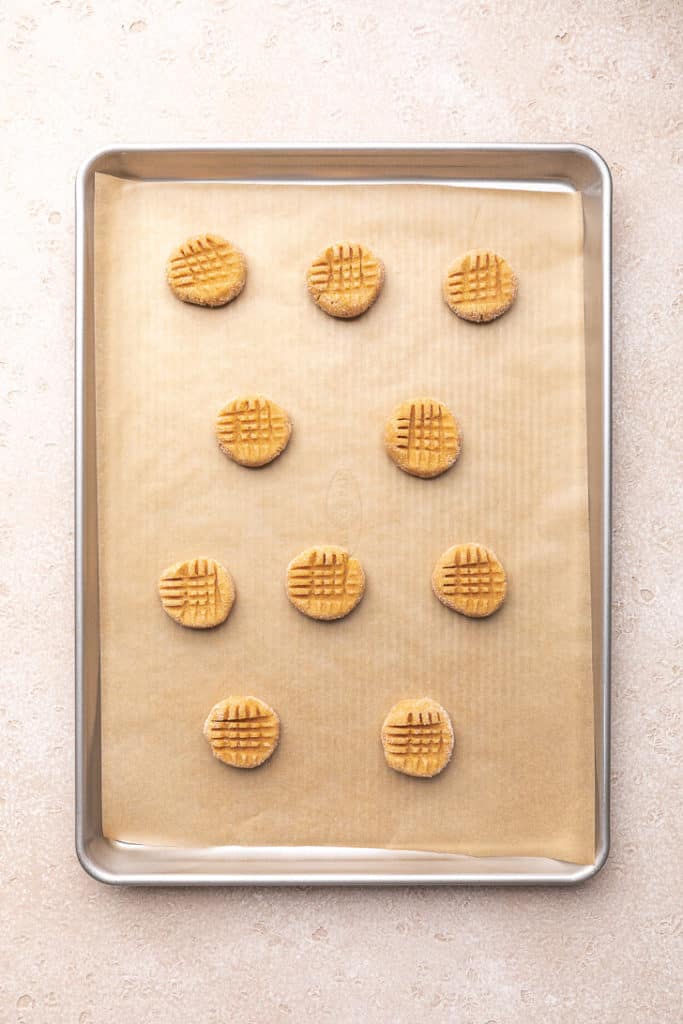 Crisscross pattern pressed into cookie dough.