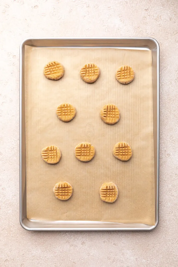 Crisscross pattern pressed into cookie dough.