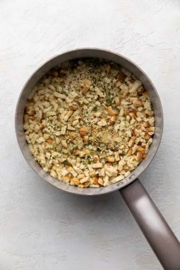 Stuffing mix poured into a pan of broth and butter.