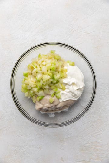 Sauteed celery and onions in a bowl of condensed soup and sour cream.