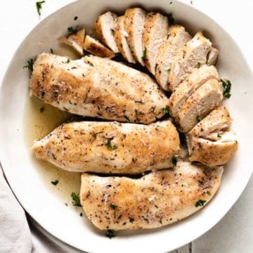 Top down view of slow cooker chicken breasts in a large serving dish.