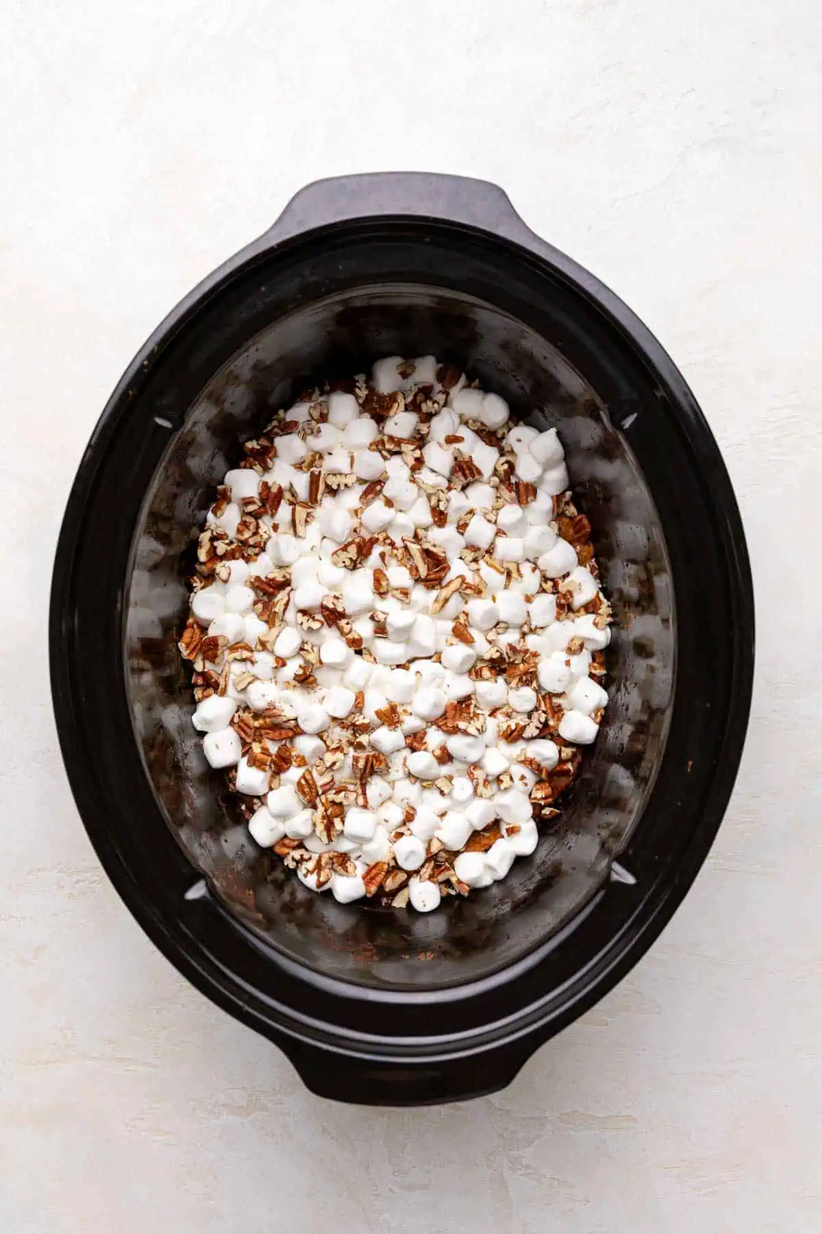 Marshmallows and pecans on top of casserole.