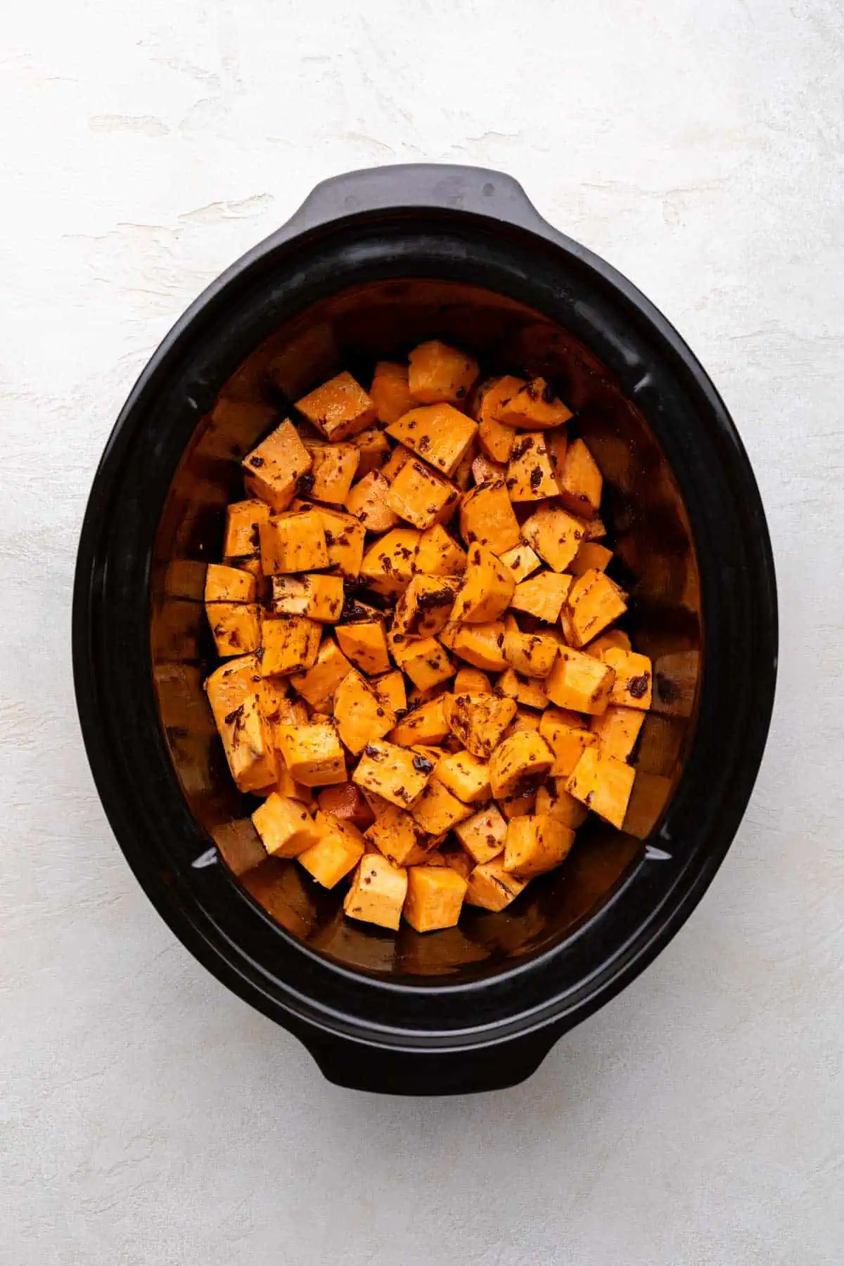 Spices and butter poured over diced spice potatoes.