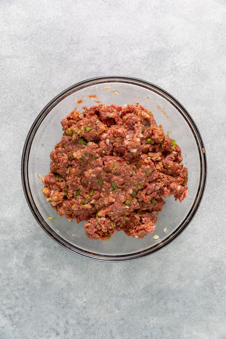 Meatloaf mixture in a glass bowl.
