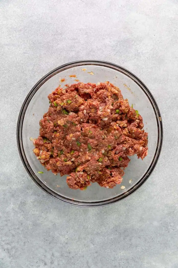 Meatloaf mixture in a glass bowl.