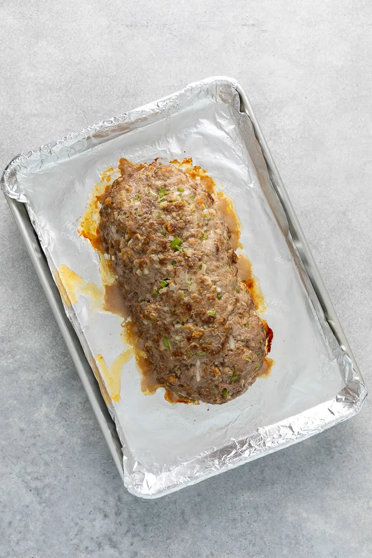 Baked meatloaf on a sheet pan.