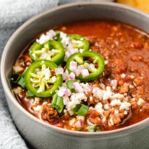 Close up view of a gray bowl filled with chili.