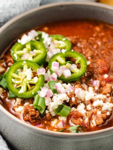 Close up view of a gray bowl filled with chili.