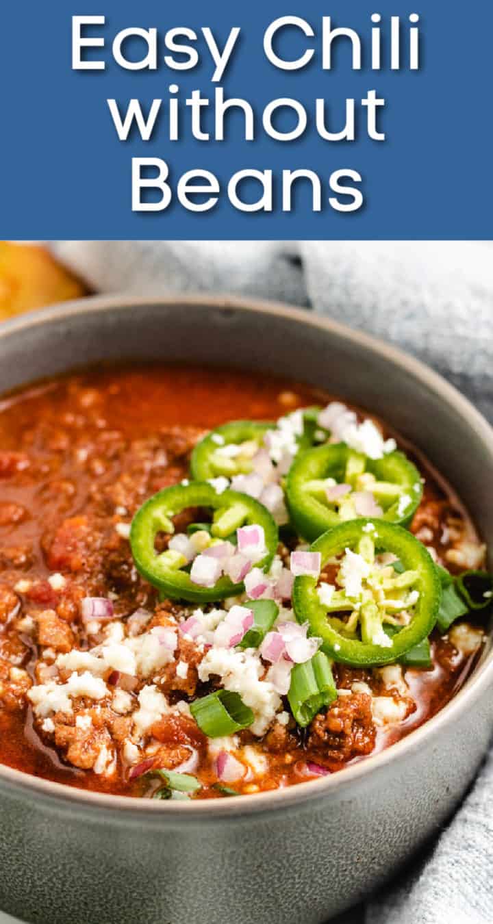 Bowl of chili topped with jalapenos and cheese.