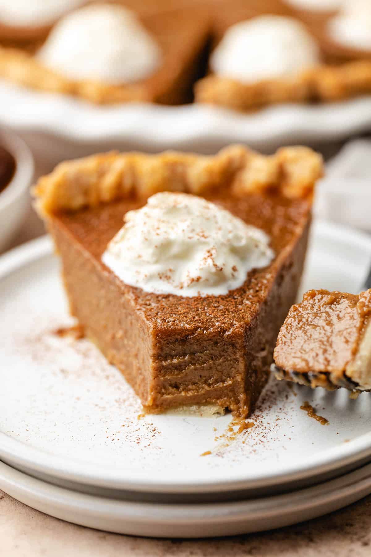 Bite taken from a slice of apple butter pie.