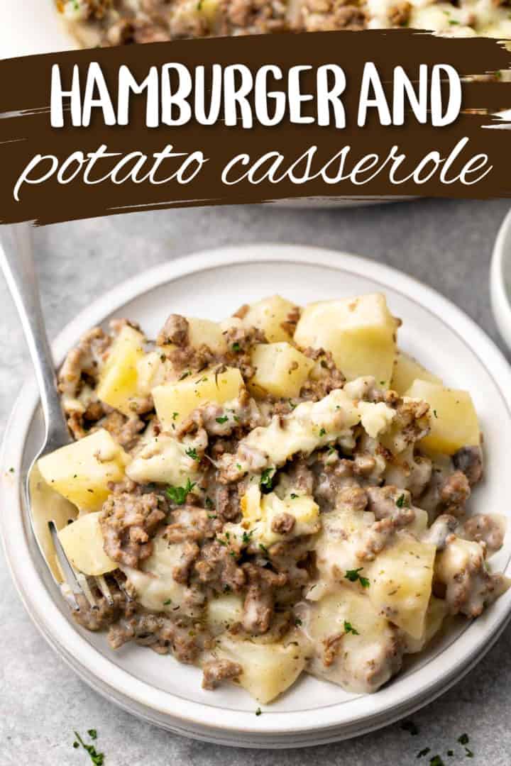 Ground beef and potato casserole on a gray plate with a fork.