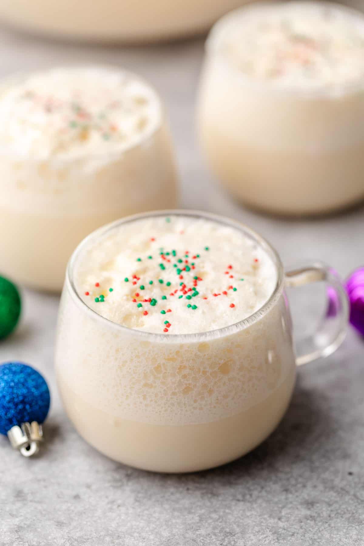 White holiday punch with sprinkles in a cup.
