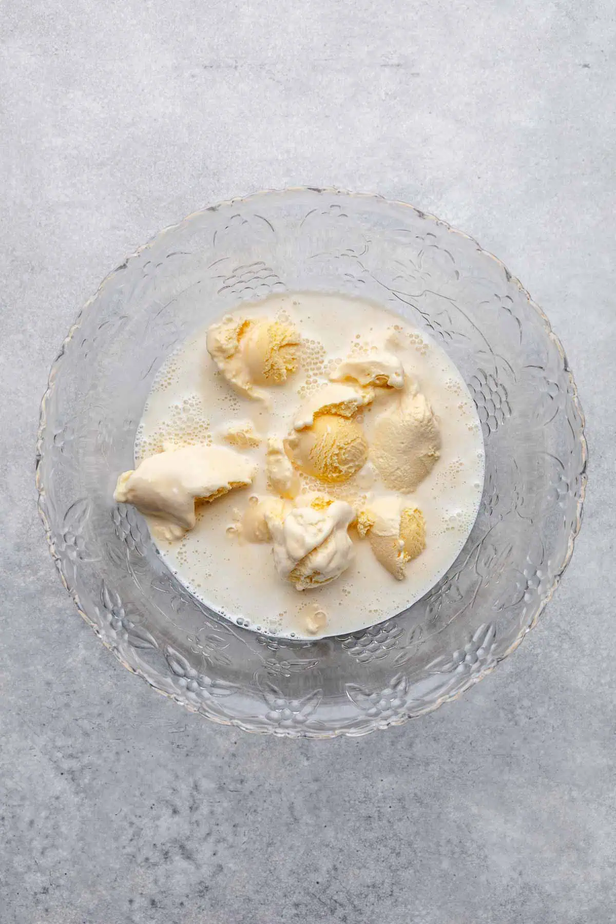 Ice cream and sweetened condensed milk in a punch bowl.