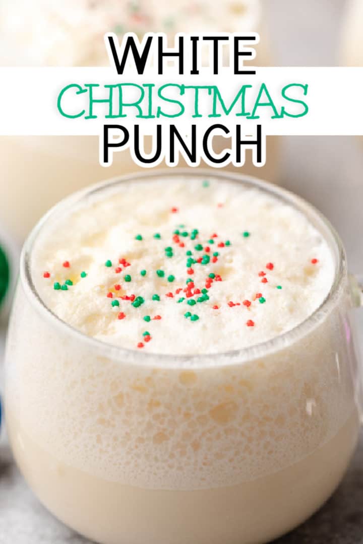 Close up view of a glass of punch with sprinkles.