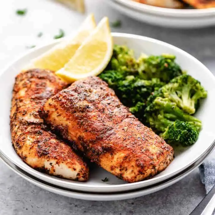 Plate filled with blackened mahi mahi and broccoli.