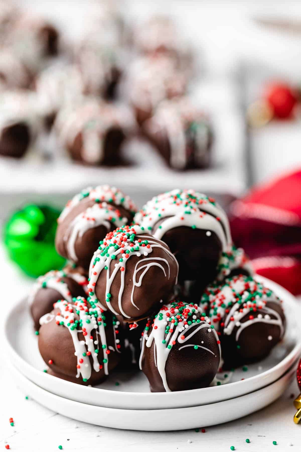 White chocolate and Christmas sprinkles on top of chocolate truffles.