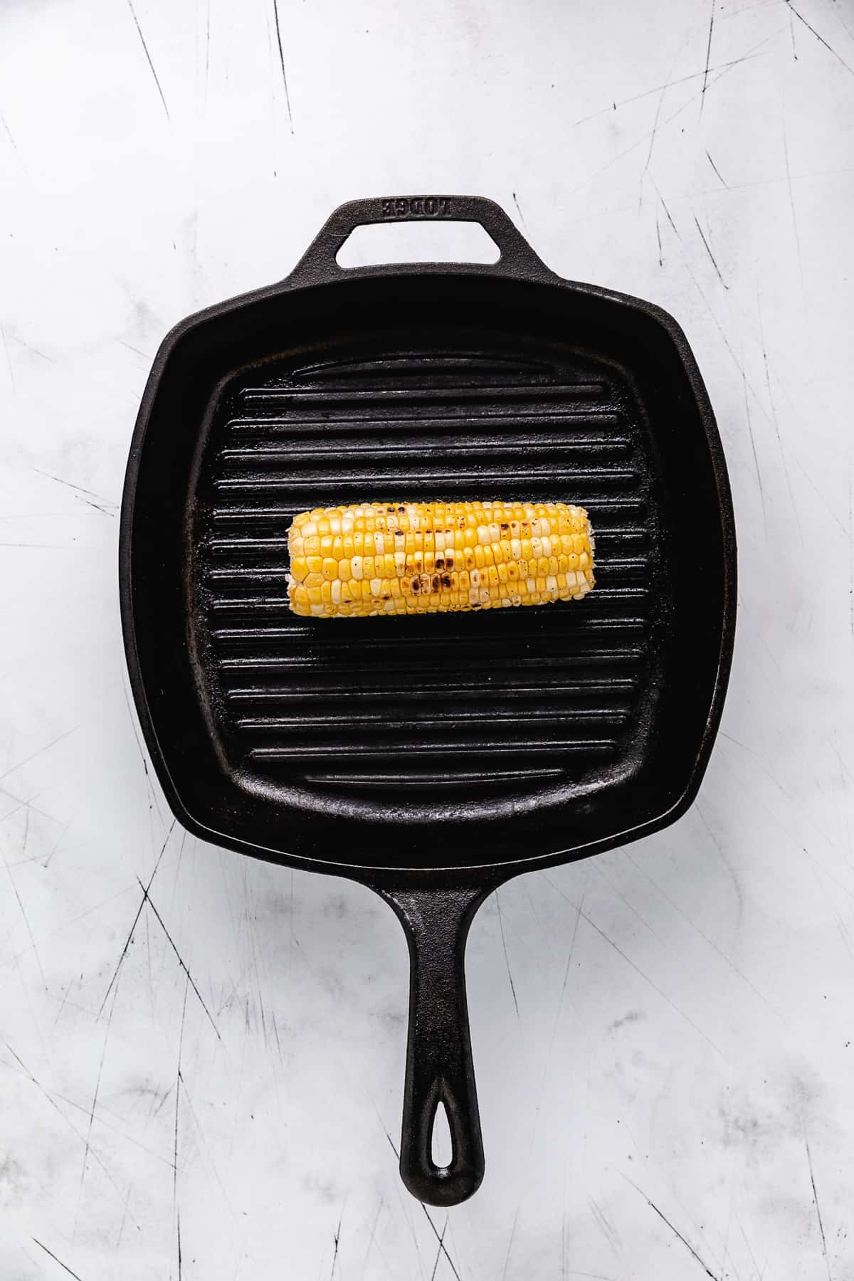 Ear of corn on a griddle pan.