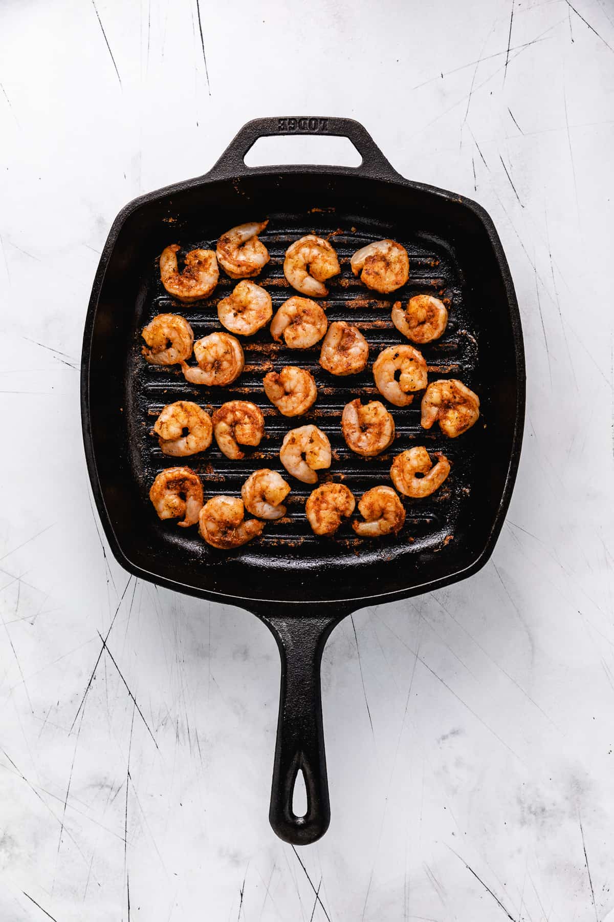 Shrimp cooking on a griddle pan.
