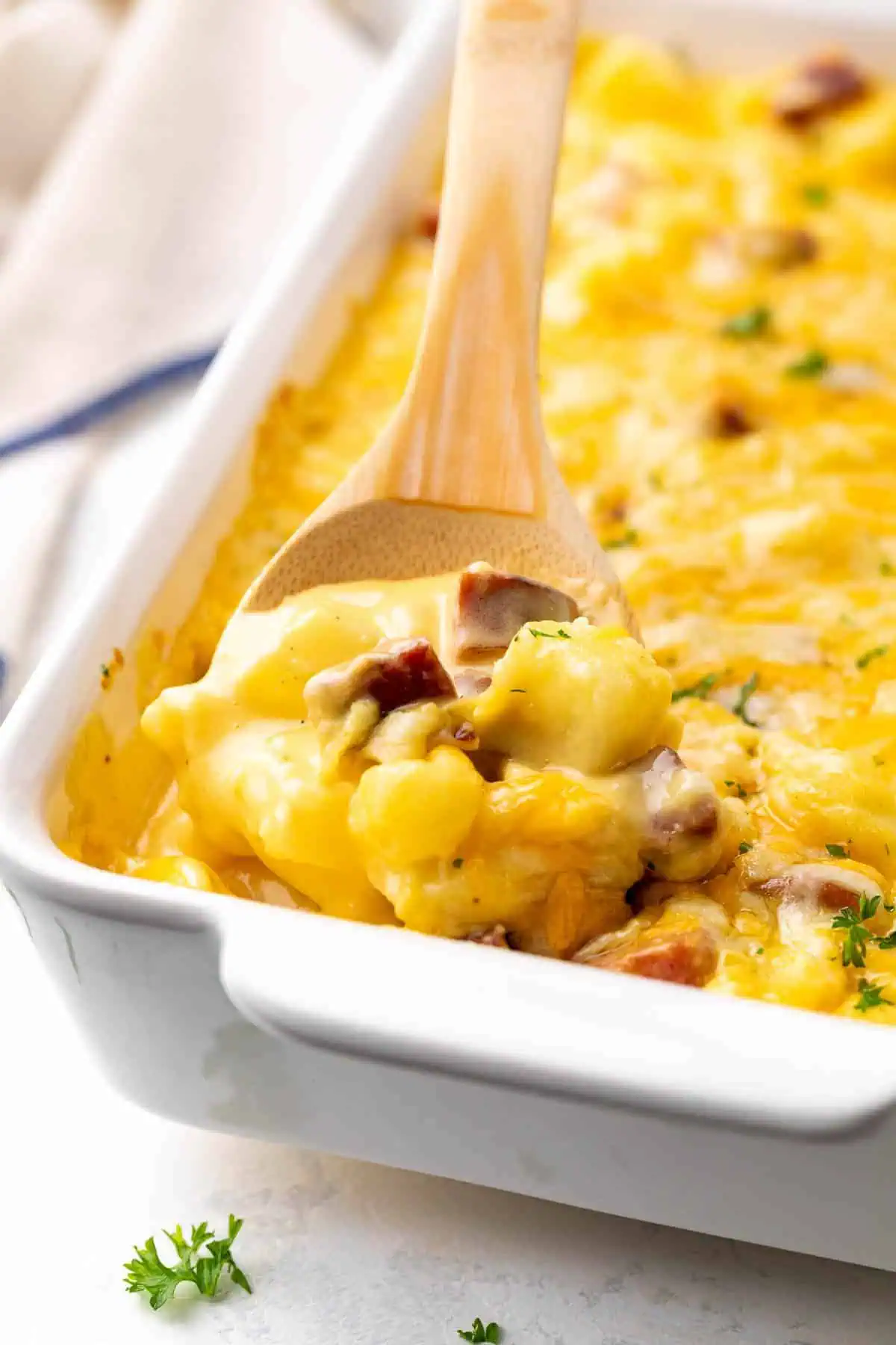 Freshly baked cheesy sausage and potato casserole in a pan.