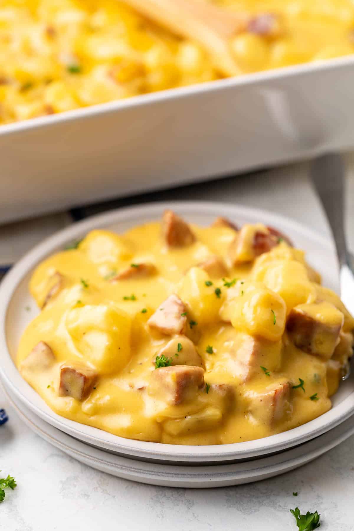 Cheese sauce over sausage and potatoes.