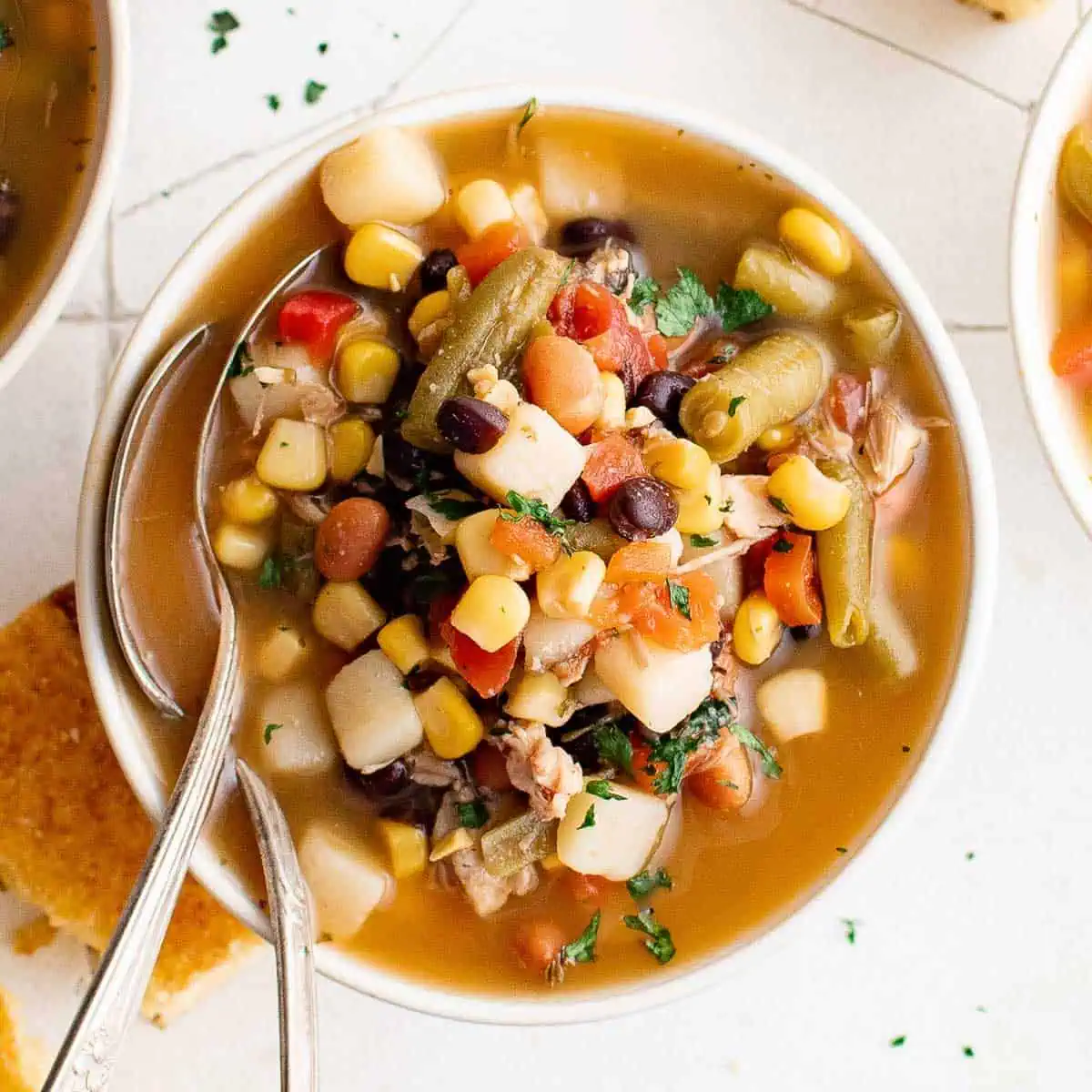 Top down view of a bowl of chicken and vegetable soup.