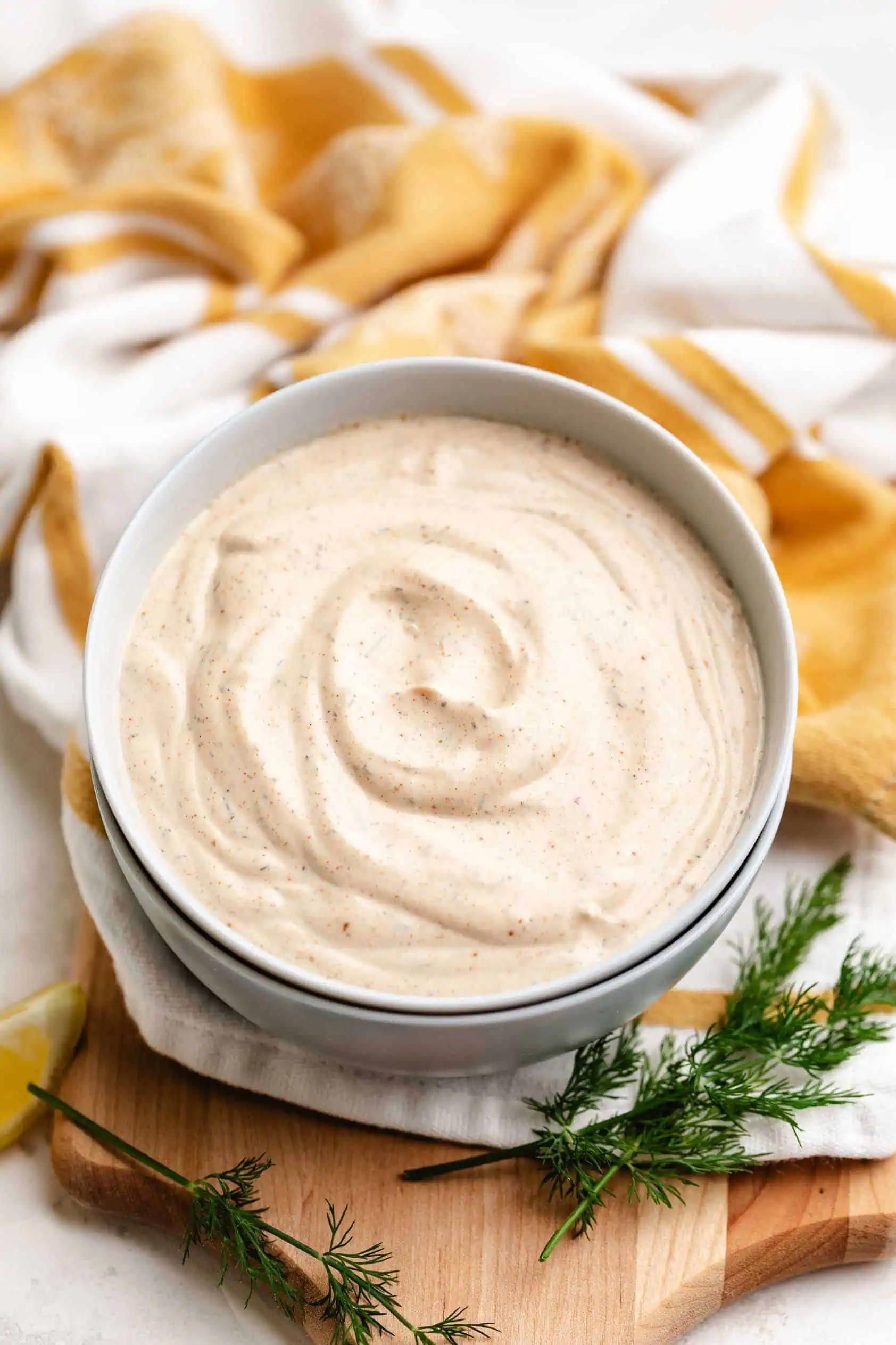 Creamy fish taco sauce in a stack of bowls.