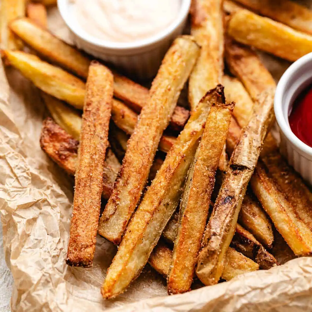 Close up view of fries on a sheet pan.