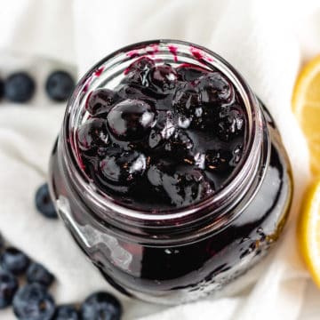 Top down view of lemon blueberry compote in a jar.