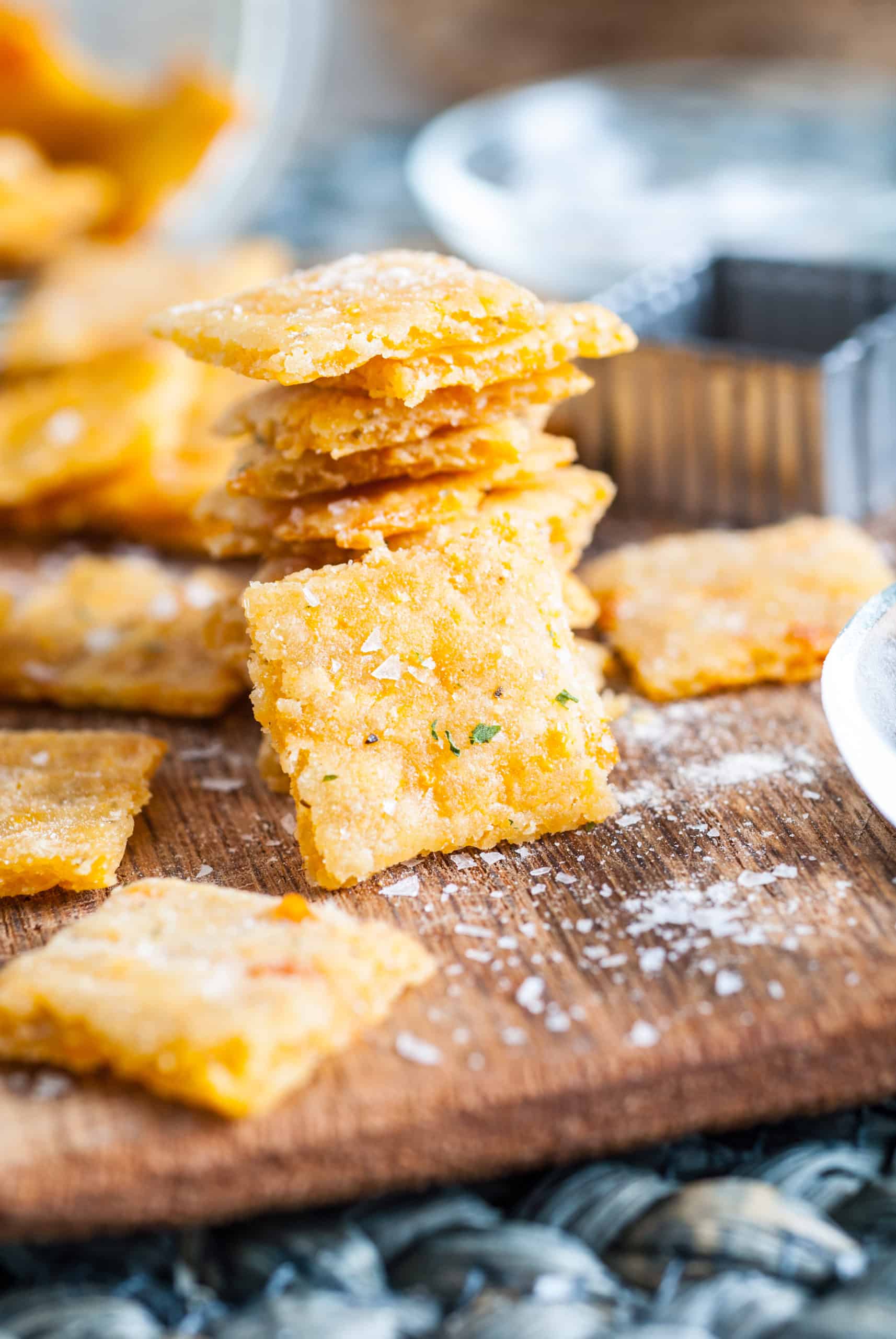 Stack of cheesy ranch crackers on a cutting board.