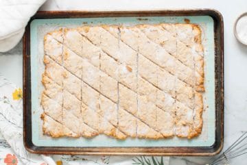 Cracker dough cut into diagonals on a pan.