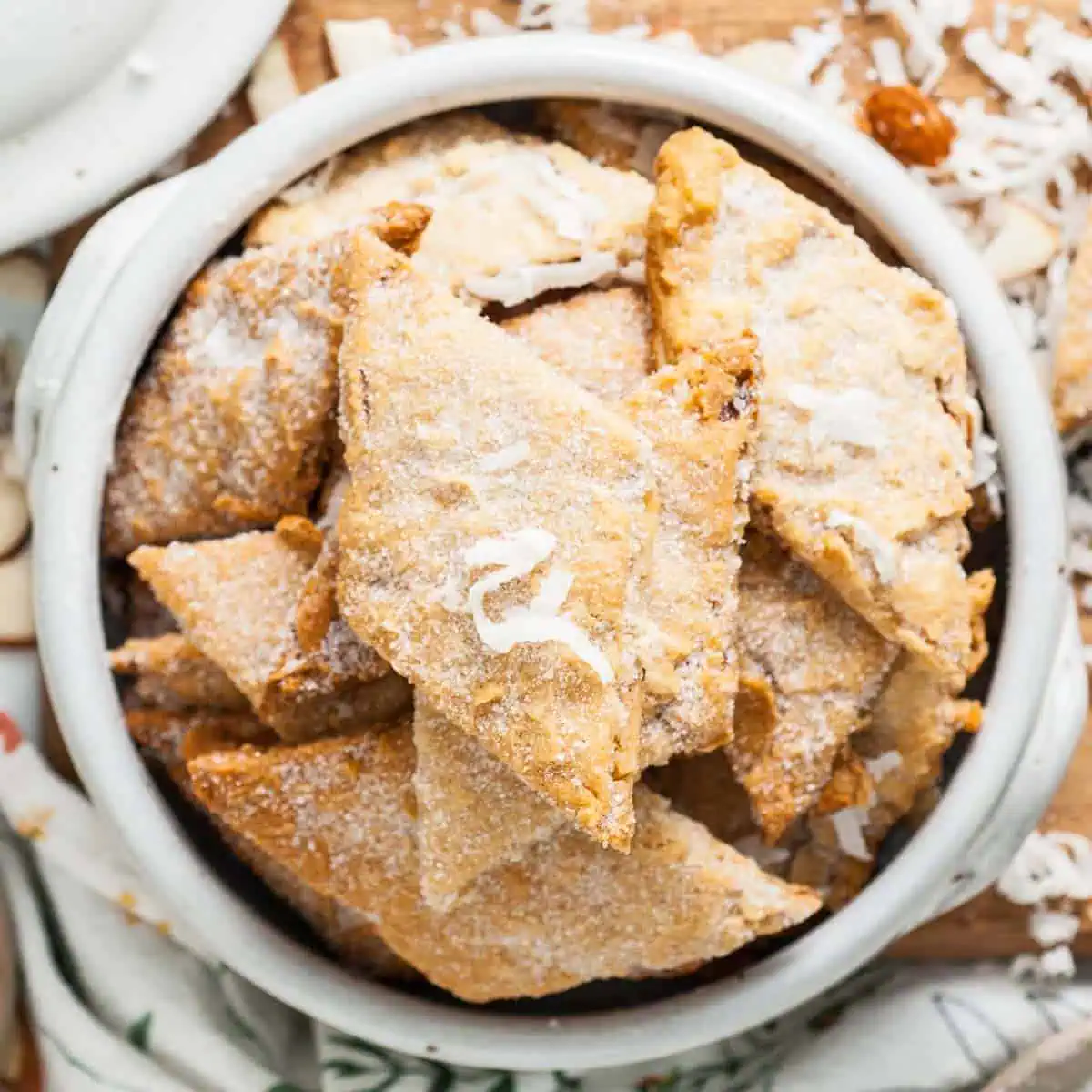 Close up view of coconut sprinkled over crackers.