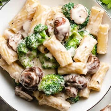 Close up view of a plate of mushroom broccoli pasta.