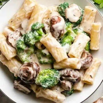 Close up view of a plate of mushroom broccoli pasta.