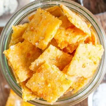 Close up view of cheddar ranch sourdough discard crackers in a jar.