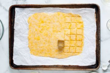 Cookie cutter cutting cracker squares.