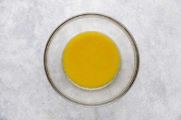 Oil, vinegar, honey mustard mixed in a bowl.