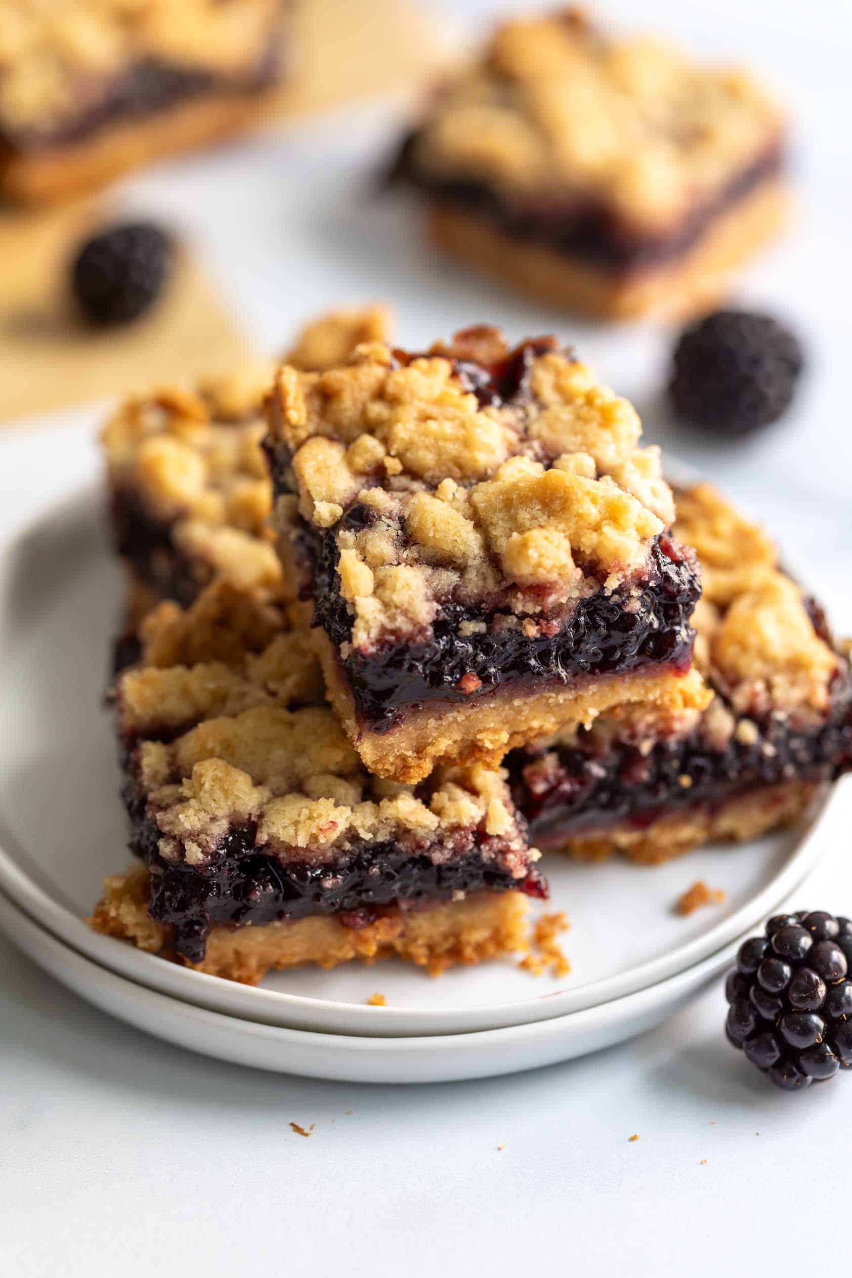 Stack of blackberry pie bars on a plate.
