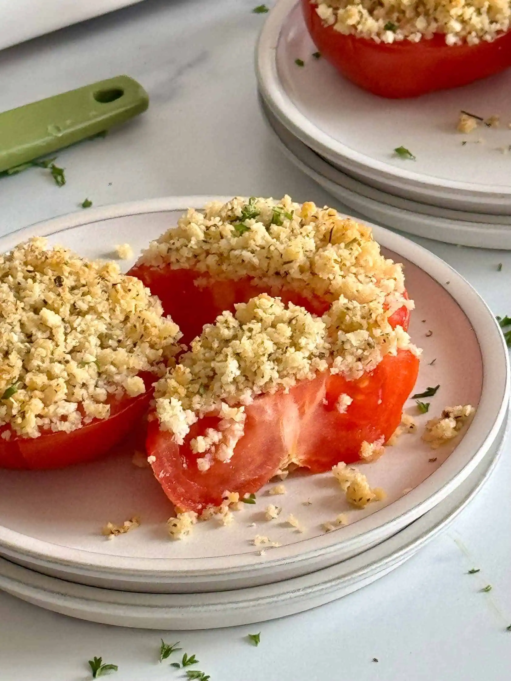 Two baked tomatoes on a plate.