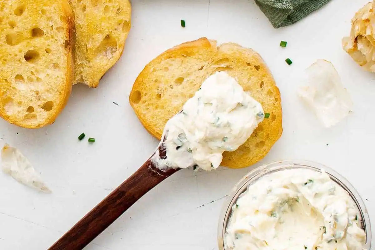 Roasted garlic butter on a knife.